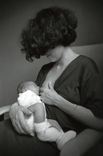 Mother breastfeeding her newborn baby boy. by Sami Sarkis Photography