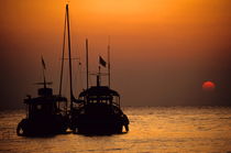Fishing boats together at sunset by Sami Sarkis Photography