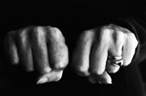 Woman clenching two hands into fists in a fit of aggression. by Sami Sarkis Photography