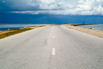 Deserted rural road on the way to Cayo Santa-Maria with the sea on either side by Sami Sarkis Photography