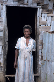 Portrait of a woman standing-up outside her home