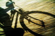 Shadow of a person riding a bicycle. von Sami Sarkis Photography