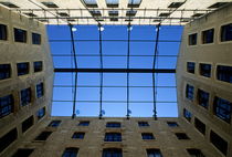 Blue sky as seen from a courtyard inside a building by Sami Sarkis Photography