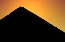 Silhouette of the Great Pyramid of Giza at sunset by Sami Sarkis Photography