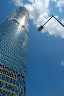 Skyscraper and street lamp with cloudy sky by Sami Sarkis Photography