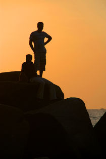 Silhouetted Figures on Rock at Sunset Palolem by serenityphotography