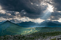 A sunbeam pierces clouds over Marmolada in the Dolomites, Italy by Tom Dempsey