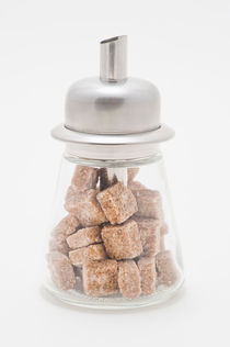 Sugar dispenser filled with brown sugar cubes by Lars Hallstrom