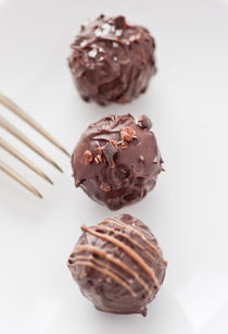 Closeup of a three chocolate truffles by Lars Hallstrom