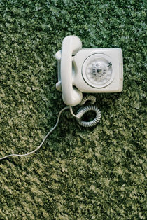 Telephone and green carpet by Lars Hallstrom