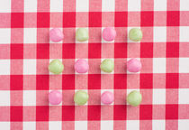 Candy on a red and white chequered tablecloth by Lars Hallstrom