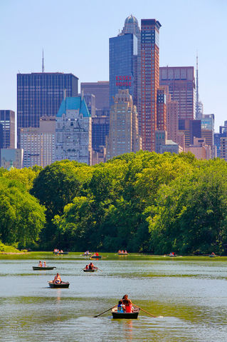 New-york-city-central-park-with-manhattan-skyline-skyscrapers-and-blue-sky-with-boat-in-lake