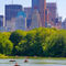 New-york-city-central-park-with-manhattan-skyline-skyscrapers-and-blue-sky-with-boat-in-lake